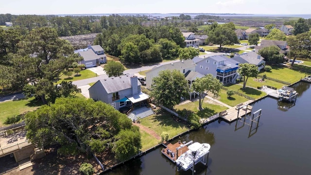 drone / aerial view featuring a residential view and a water view