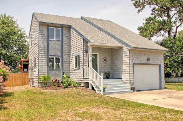 view of front of house with a garage, a shingled roof, concrete driveway, fence, and a front yard