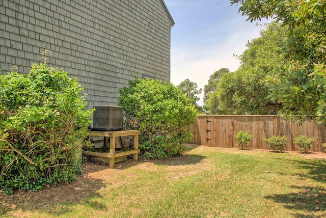 view of yard with cooling unit and fence