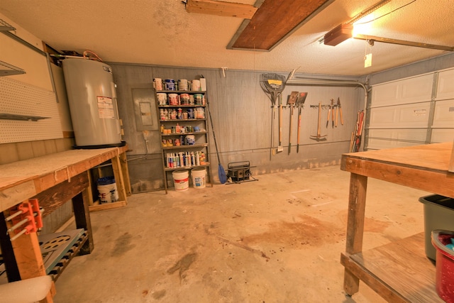 below grade area featuring a garage, a textured ceiling, water heater, and a workshop area