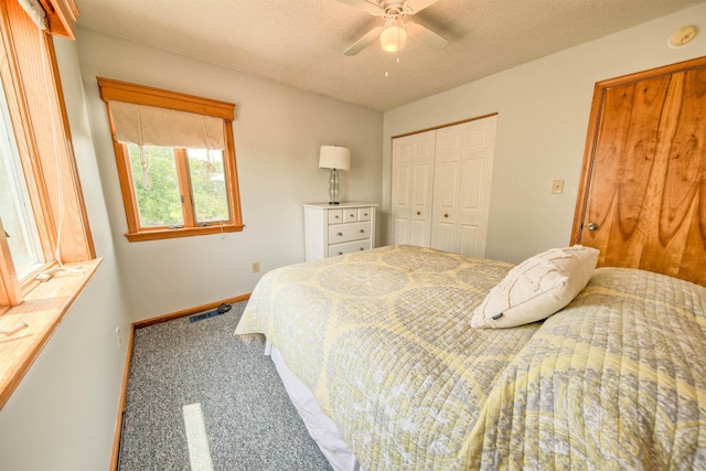 bedroom featuring baseboards, a textured ceiling, visible vents, and carpet flooring