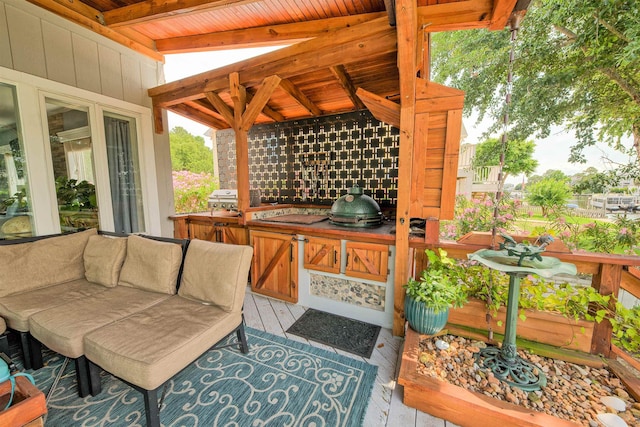 exterior space featuring a grill, an outdoor kitchen, and a wooden deck