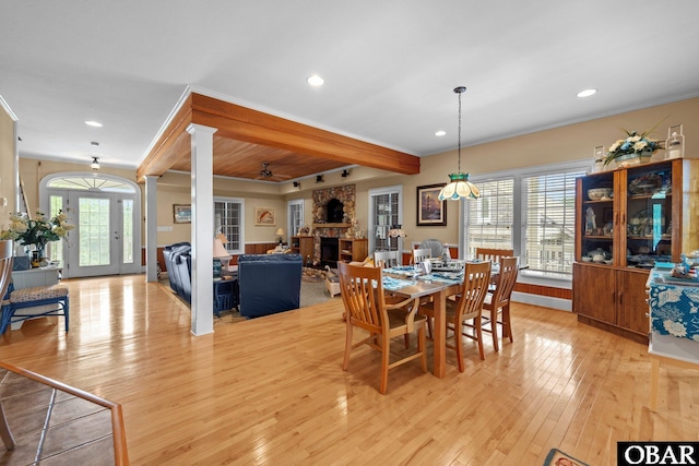 50112 Captains Ct Lot 221, Frisco, NC 27936 - dining room featuring a stone fireplace, light wood-style floors, decorative columns, beamed ceiling, and recessed lighting