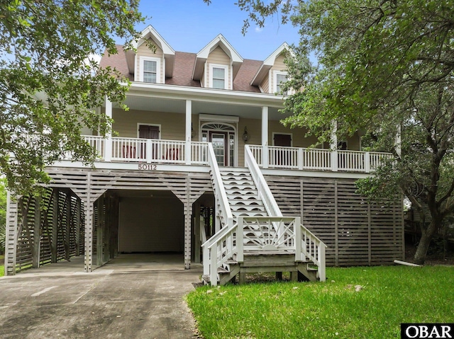 50112 Captains Ct Lot 221, Frisco, NC 27936 - raised beach house featuring a carport, covered porch, driveway, and stairs