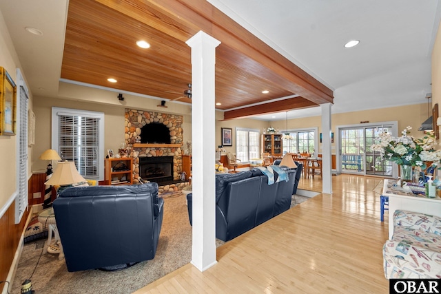 50112 Captains Ct Lot 221, Frisco, NC 27936 - living room featuring decorative columns, a fireplace, wood finished floors, a wood ceiling with exposed beams, and a ceiling fan