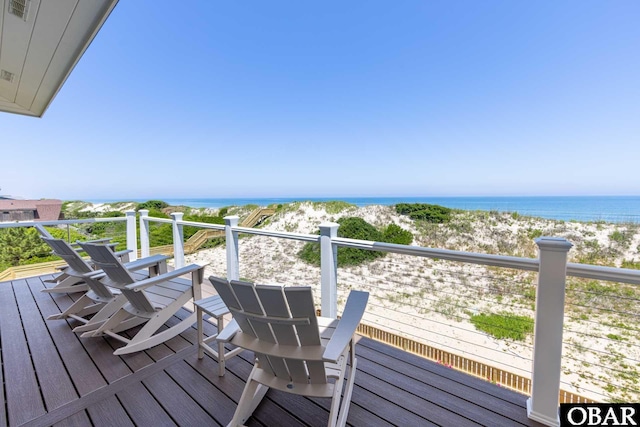 balcony featuring a beach view and a water view