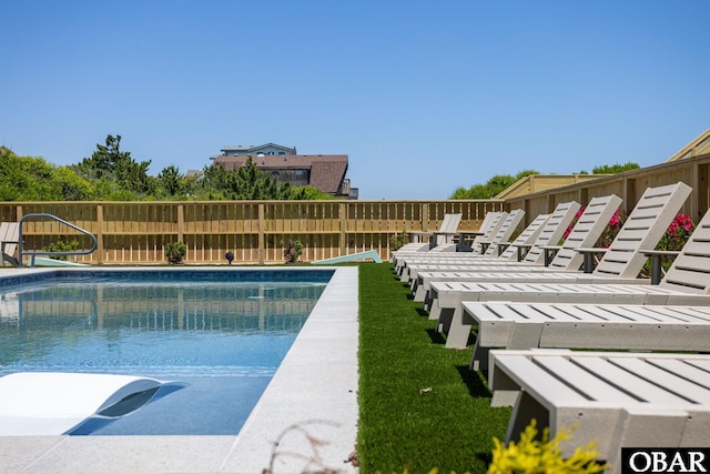 view of swimming pool featuring fence and a fenced in pool