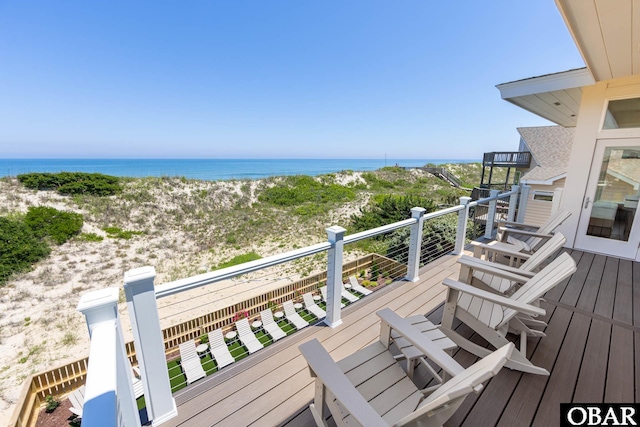 deck featuring a water view and a view of the beach