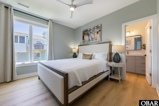 bedroom with light wood finished floors, baseboards, visible vents, and a ceiling fan