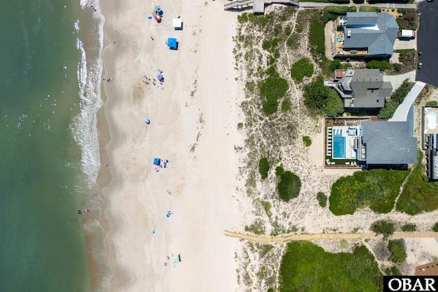 birds eye view of property featuring a water view and a view of the beach