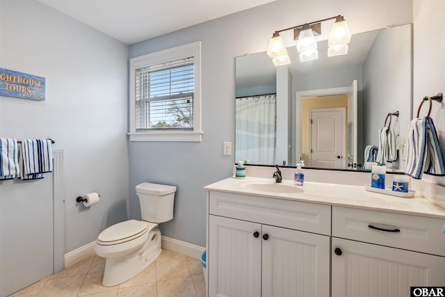 bathroom with curtained shower, tile patterned flooring, toilet, vanity, and baseboards