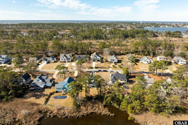 drone / aerial view with a residential view and a water view