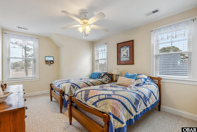 bedroom with light carpet, visible vents, and baseboards