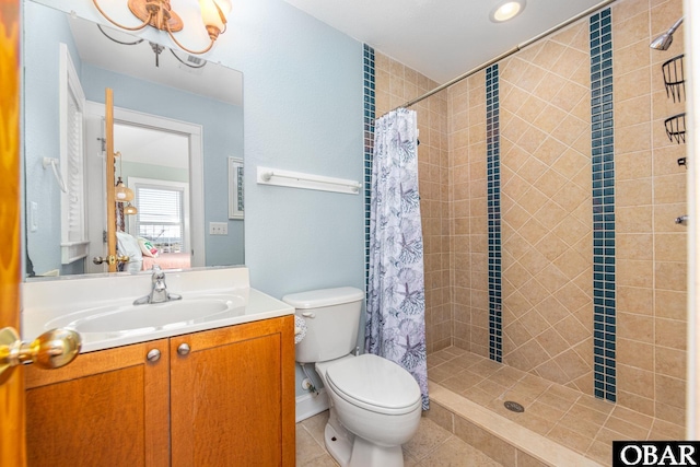 bathroom featuring toilet, a shower stall, ensuite bath, vanity, and tile patterned flooring