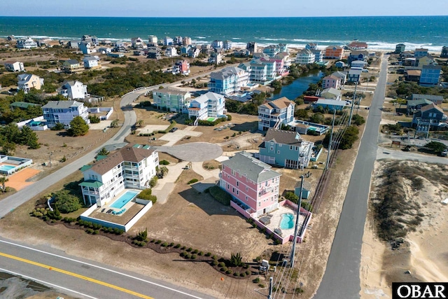 drone / aerial view featuring a view of city and a water view