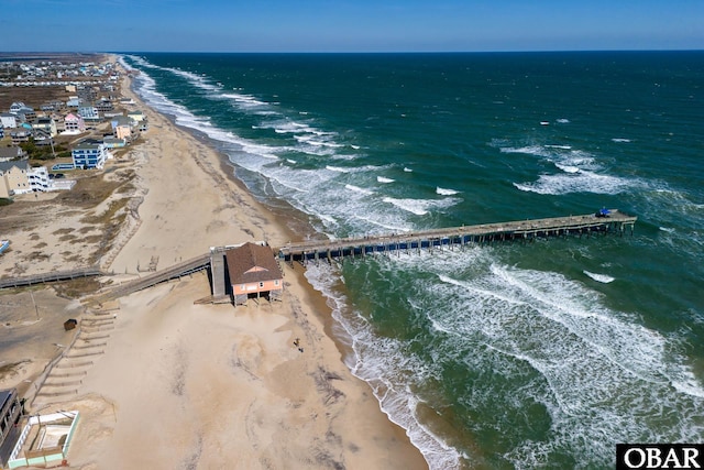 bird's eye view with a water view and a beach view