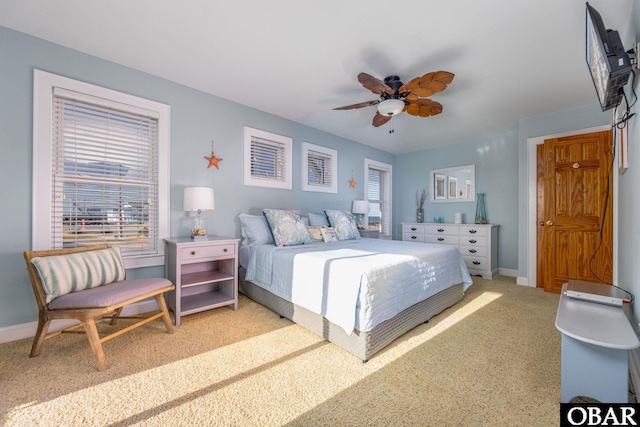 carpeted bedroom featuring ceiling fan and baseboards