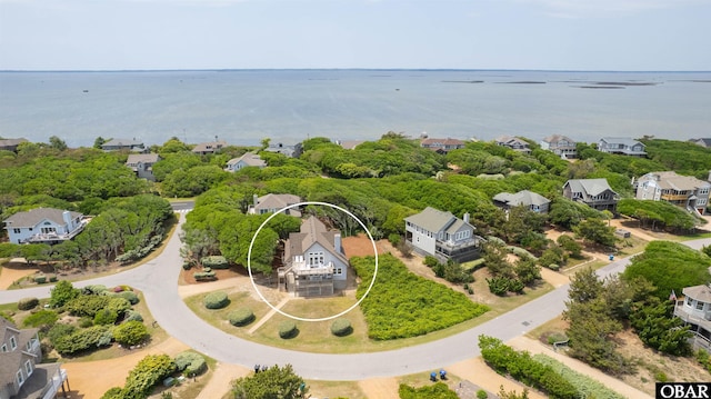 drone / aerial view with a water view and a residential view