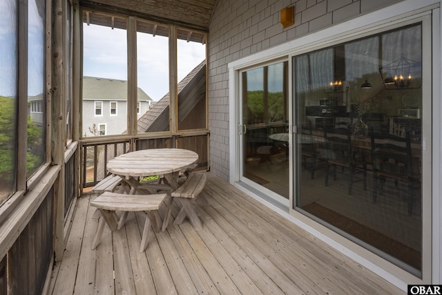 sunroom / solarium with outdoor dining area and plenty of natural light