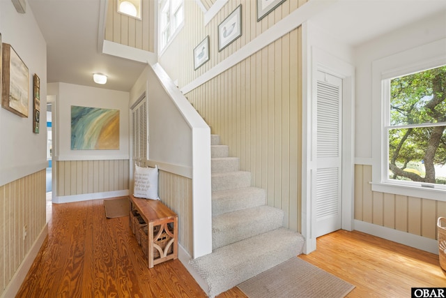 123 Martin Ln Lot 251, Duck, NC 27949 - staircase with baseboards, wainscoting, and wood finished floors