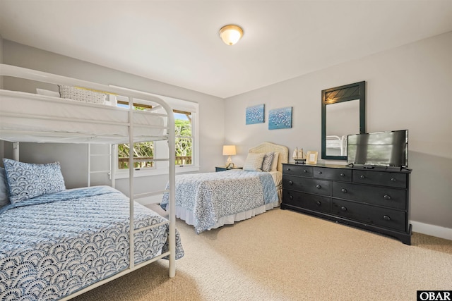 bedroom with baseboards and carpet