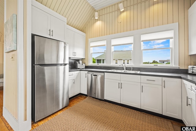 123 Martin Ln Lot 251, Duck, NC 27949 - kitchen featuring wood finished floors, a sink, dark countertops, stainless steel appliances, and lofted ceiling