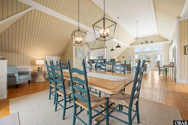 123 Martin Ln Lot 251, Duck, NC 27949 - dining area with lofted ceiling, a chandelier, and wood finished floors