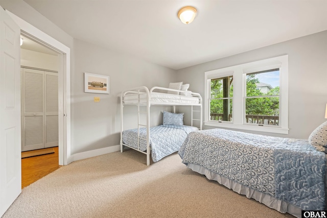 bedroom featuring carpet floors and baseboards