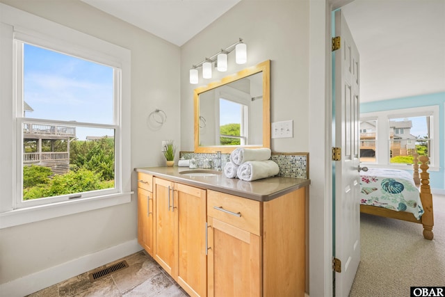123 Martin Ln Lot 251, Duck, NC 27949 - ensuite bathroom with baseboards, ensuite bath, visible vents, vanity, and backsplash