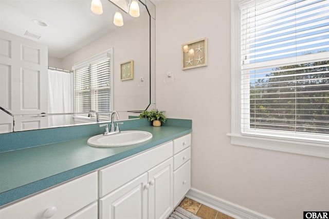 full bathroom with baseboards and vanity