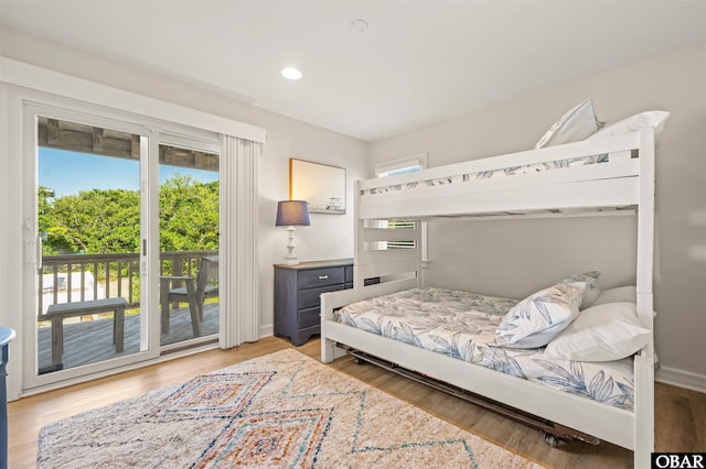 bedroom featuring access to outside, wood finished floors, recessed lighting, and baseboards