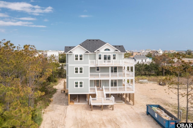 back of property with stairs and a balcony
