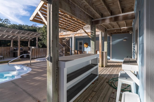 wooden deck with a pergola and area for grilling