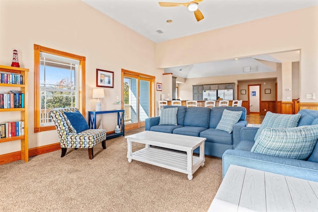 living room featuring light carpet, ceiling fan, and visible vents