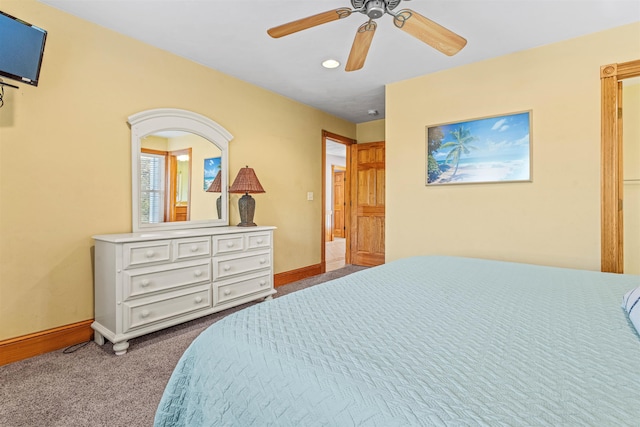 carpeted bedroom featuring ceiling fan and baseboards