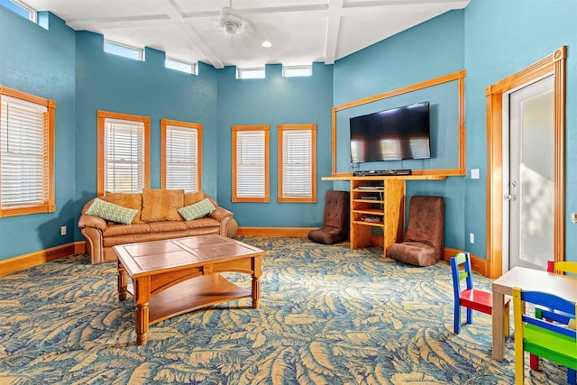 carpeted living area with coffered ceiling and baseboards