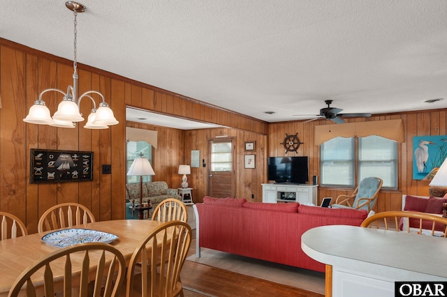 dining area featuring visible vents, ceiling fan, a textured ceiling, and wood finished floors