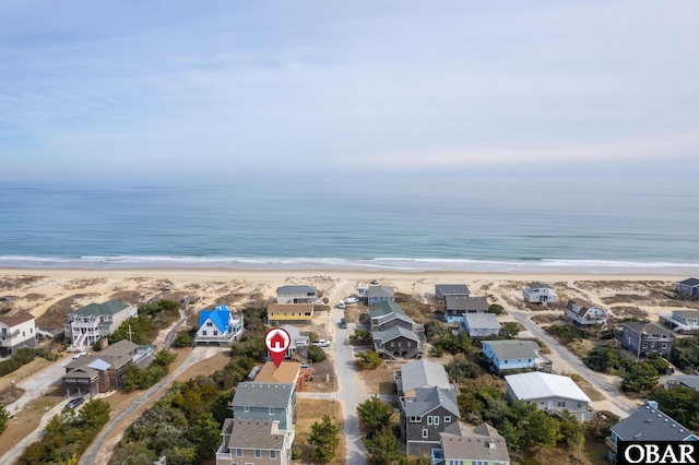 bird's eye view with a view of the beach, a water view, and a residential view