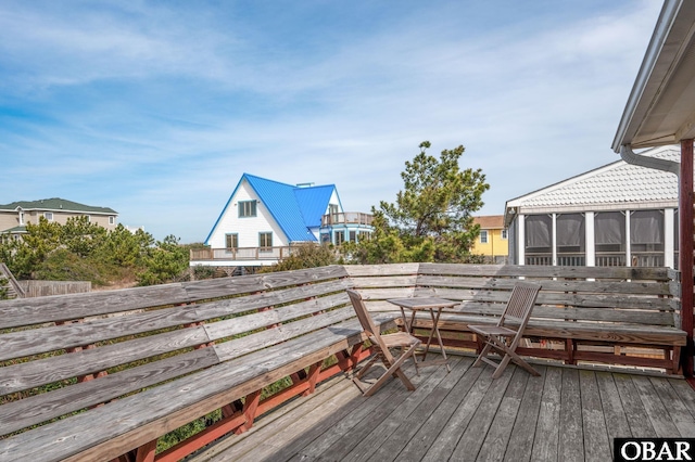 wooden deck with a sunroom