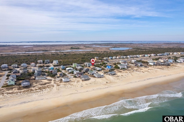 birds eye view of property with a view of the beach and a water view