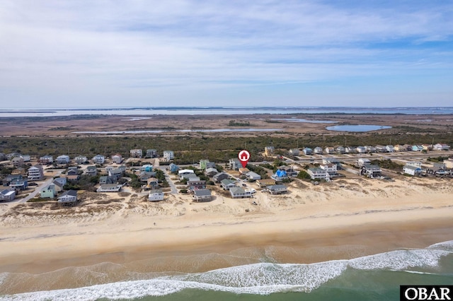 birds eye view of property with a beach view and a water view