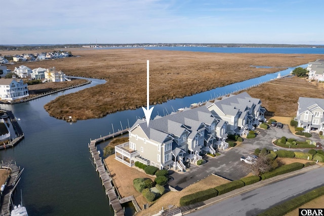 drone / aerial view featuring a water view and a residential view