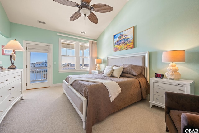 bedroom with access to outside, light carpet, vaulted ceiling, and visible vents