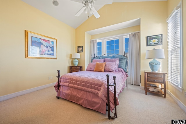 carpeted bedroom with a ceiling fan, vaulted ceiling, and baseboards