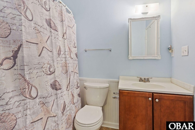 1401 N Virginia Dare Trl Unit # 5C, Kill Devil Hills, NC 27948 - full bathroom featuring vanity, wainscoting, toilet, and a shower with curtain