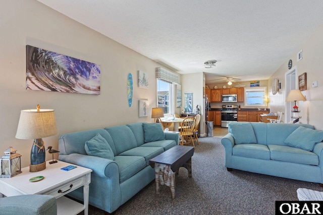 1401 N Virginia Dare Trl Unit # 5C, Kill Devil Hills, NC 27948 - living room featuring light colored carpet, a textured ceiling, and a ceiling fan