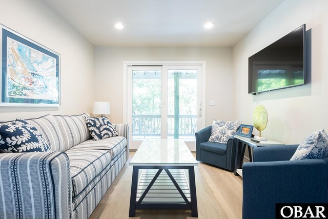 living room featuring light wood finished floors and recessed lighting