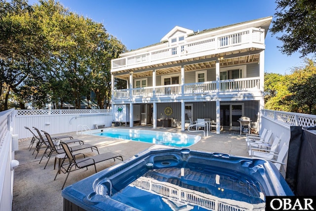 back of house with a patio, fence, an outdoor hot tub, and a fenced in pool