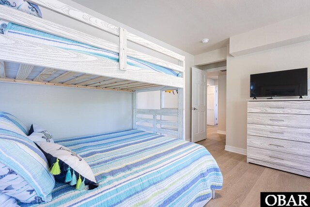 bedroom featuring light wood-style floors and baseboards