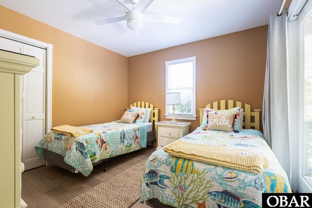 bedroom with ceiling fan and dark wood-type flooring